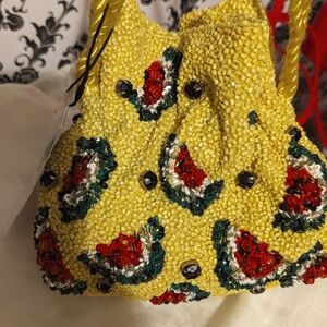 Bucket bag with beaded exterior and watermelon pattern detail. Lined interior.